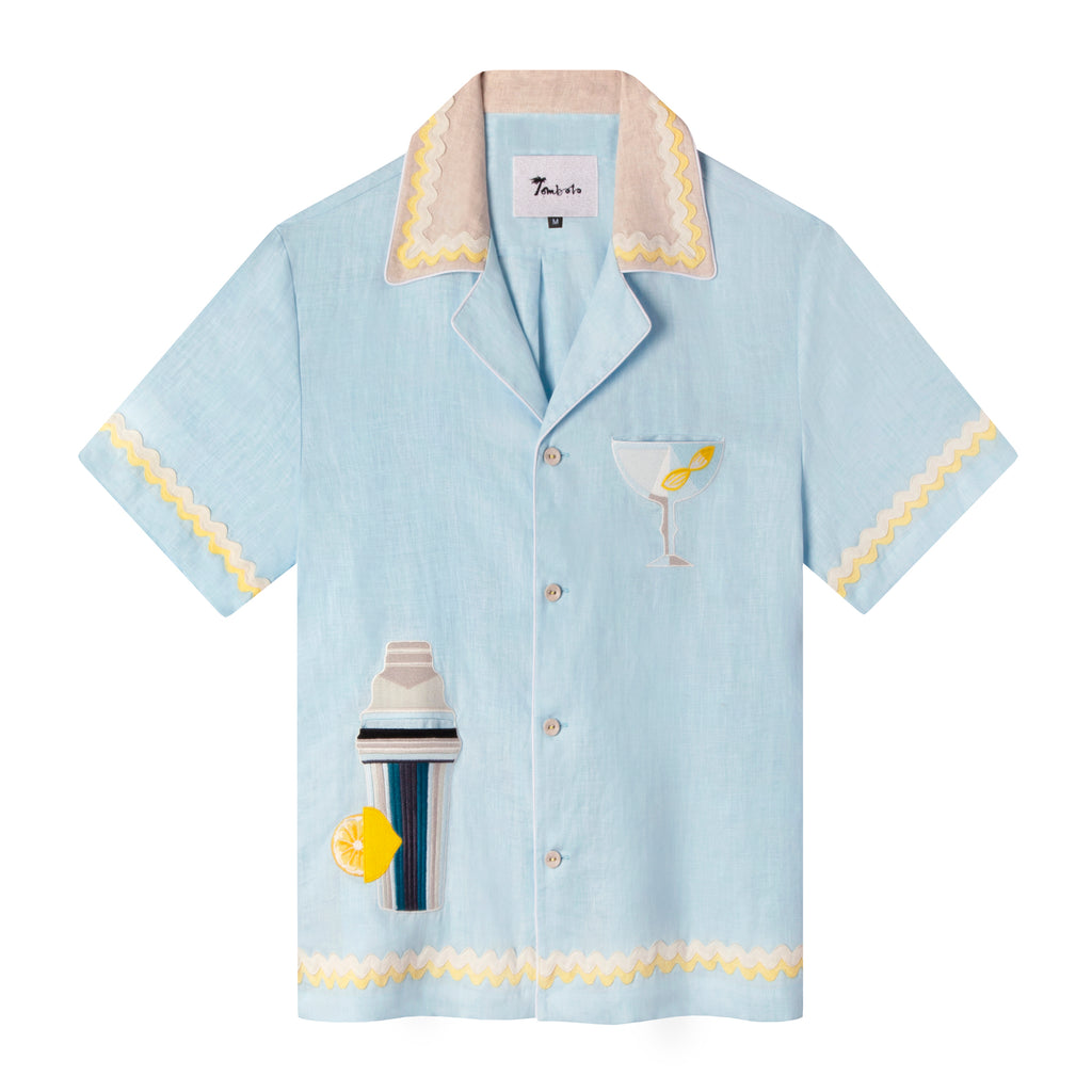 Casual, cabana style baby blue button-up Tombolo linen shirt with lemon flat ruffle trim, cocktail shaker pocket on bottom right and martini glass on right breast pocket