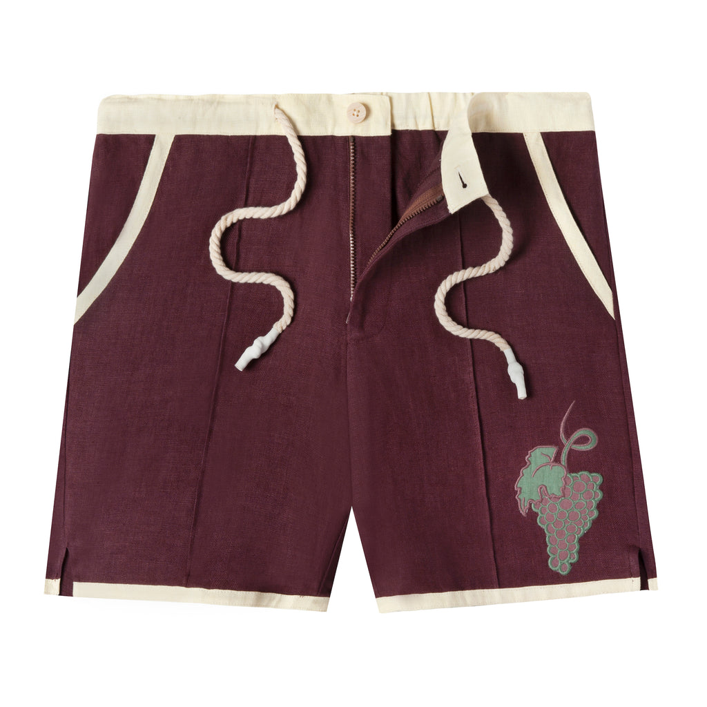 Eggplant-colored linen cabana shirts with appliquéd and edge-embroidered grape vine. This image showcases the zip fly and button closure