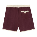 Back view of eggplant-colored linen cabana shirts with appliquéd and edge-embroidered grape vine.