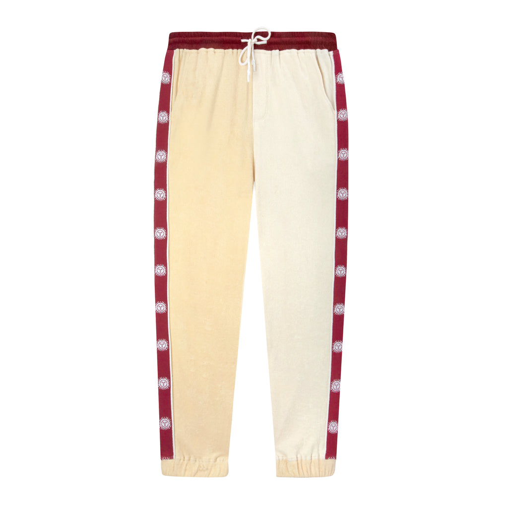 Front lay flat product photo of apres ski pants in yellow and maroon