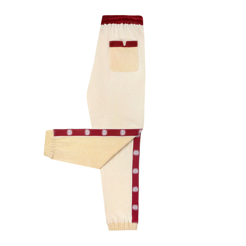 Side view of pants with leg up showing sun motif