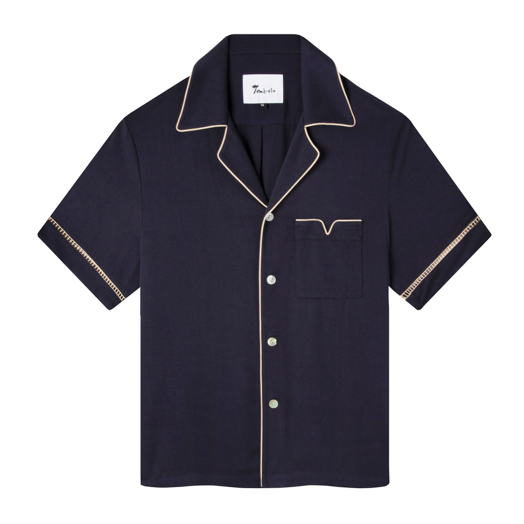 Front view of the Navy Cabrisa shirt featuring window pane embroidery on sleeves and beige piping along the pocket and collar with four white buttons down the front