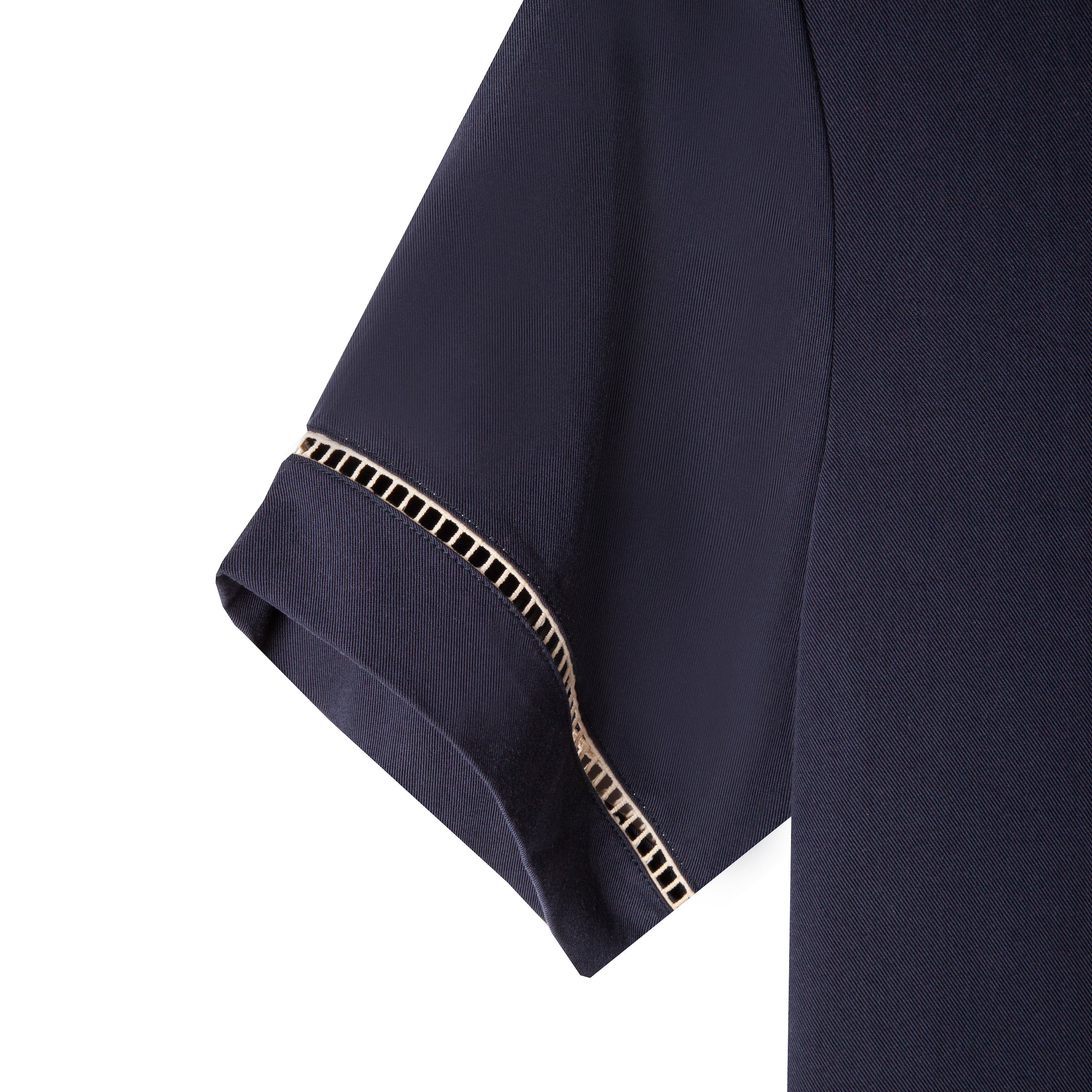 Close up of the beige window pane embroidery on the left sleeve cuff