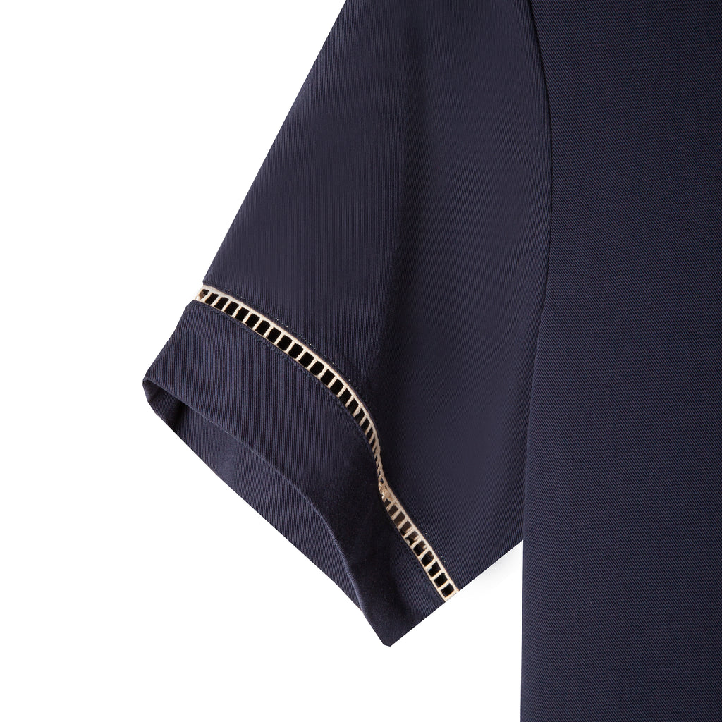 Close up of the beige window pane embroidery on the left sleeve cuff