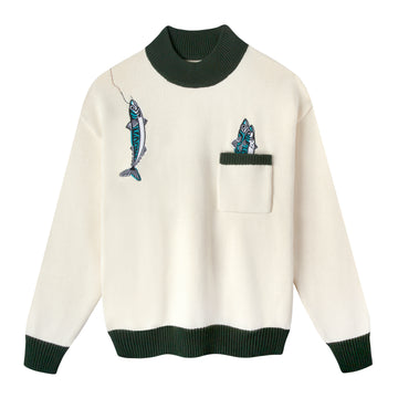 Front view of this drop shoulder, mock neck sweater which is beige with forest green contrasts along the ribbed collar, cuffs, top of pocket, and hem, also features an embroidered over-the-shoulder fish along with two fish peeking out of the front pocket