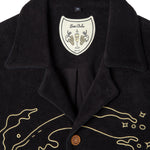 Close up of interior label showing Tom bolo Brut and a drawing of champagne flute with grapes