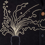 Close up of champagne spraying out of bottle top