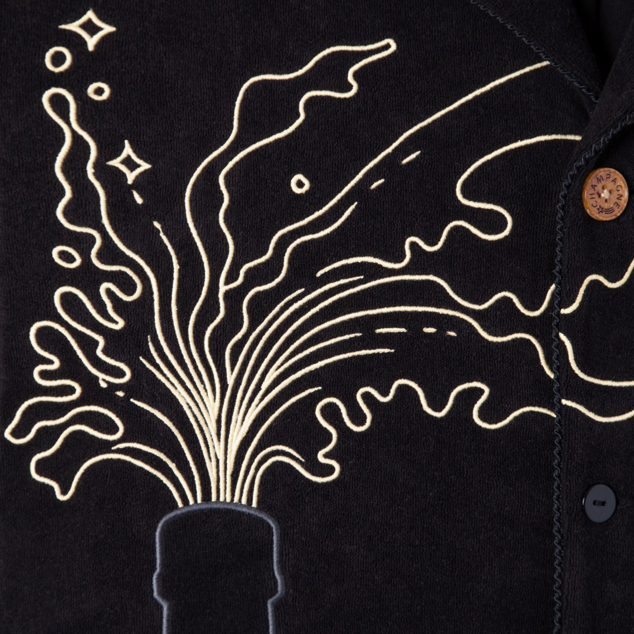 Close up of champagne spraying out of bottle top