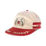 Right side view of Le Sirenuse hat, says Le Sirenuse in red between two red stripes