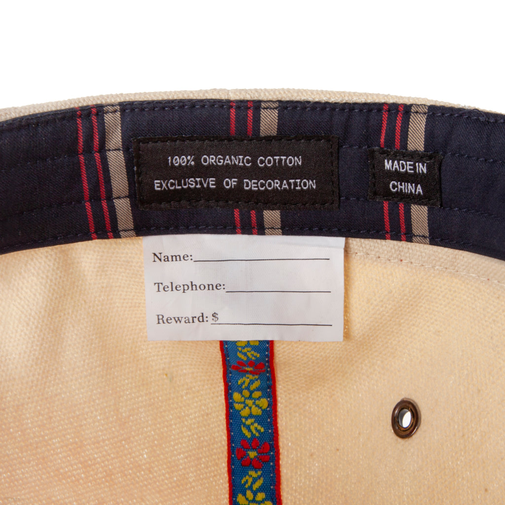 Inside of hat showing the tag with space to write your name, telephone number, and reward money