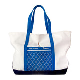Product photo of the hôtel magique tote bag showing the blue contrasts and navy bottom as well as the appliqued intrepid diver