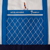 close up of blue outer pocket of bag covered in a white holey mesh