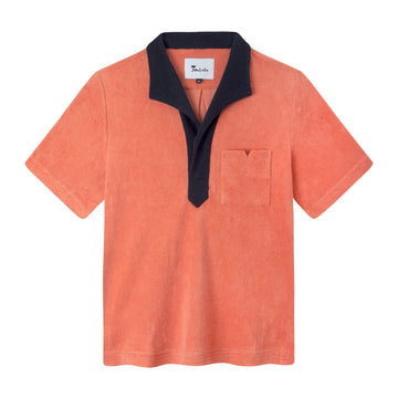 flat lay product photo of our boxy polo in apricot with a navy contrast collar