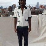 Male model wearing the shirt on a rooftop in a city with black pants