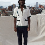 Male model wearing the shirt on a rooftop in a city with black pants