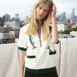 Female model wearing shirt on the rooftop overlooking the city two thirds unzipped