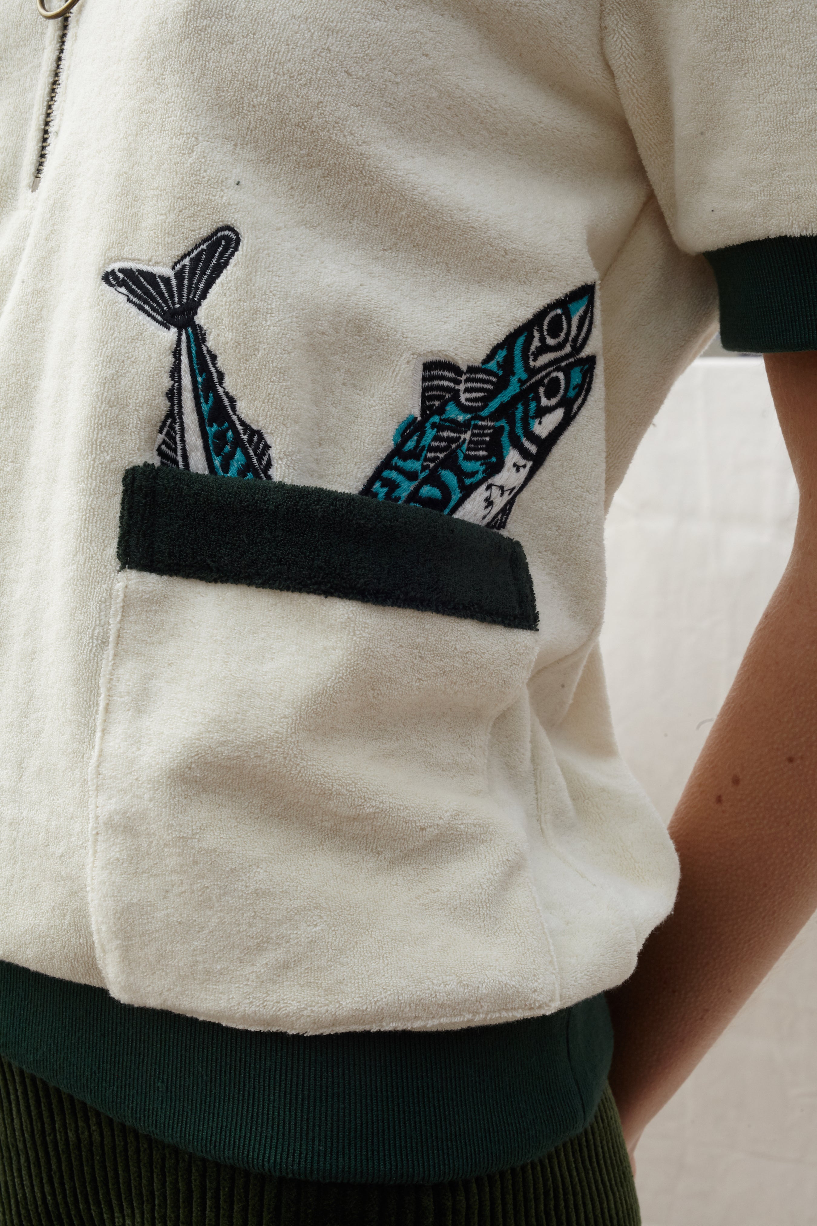 Close up of the right pocket lined with two embroidered fish