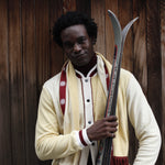 Male model close up holding skis and smiling at camera