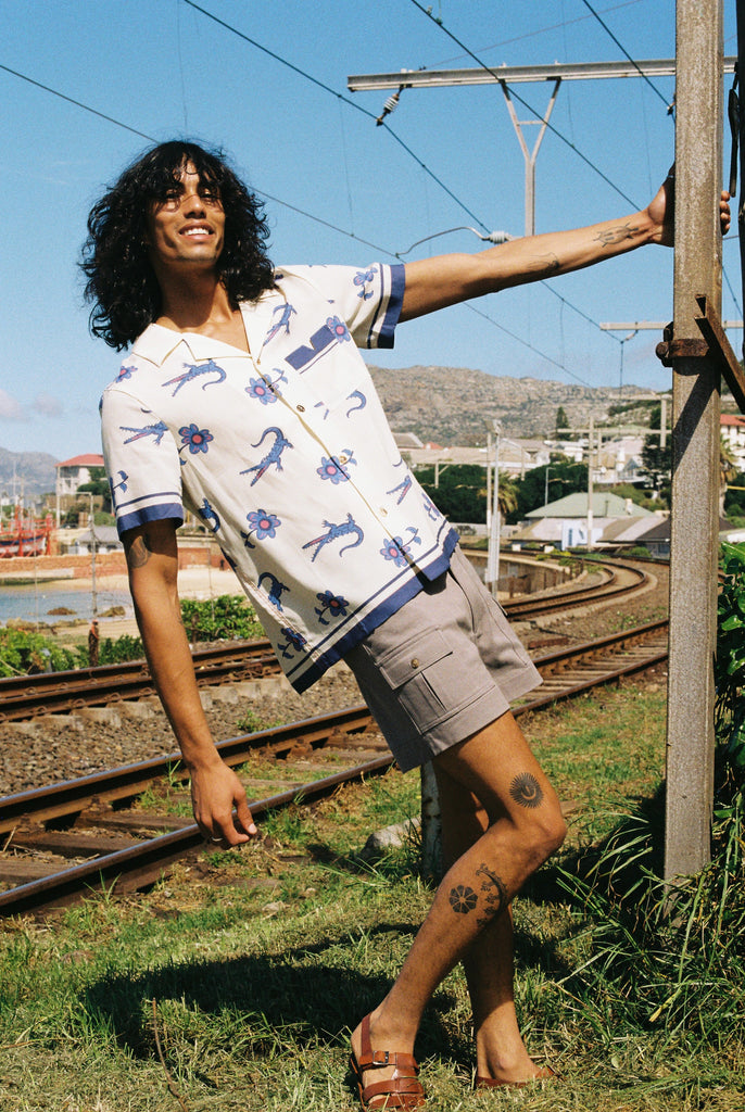 Male model wearing shirt holding a pole and leaning back