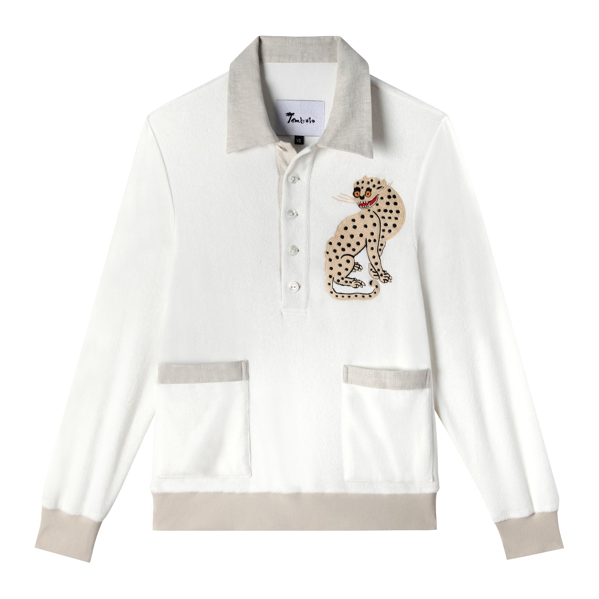 Lay flat product photo of sun leopard cabana depicting gray contrasts and appliqued leopard on upper right chest