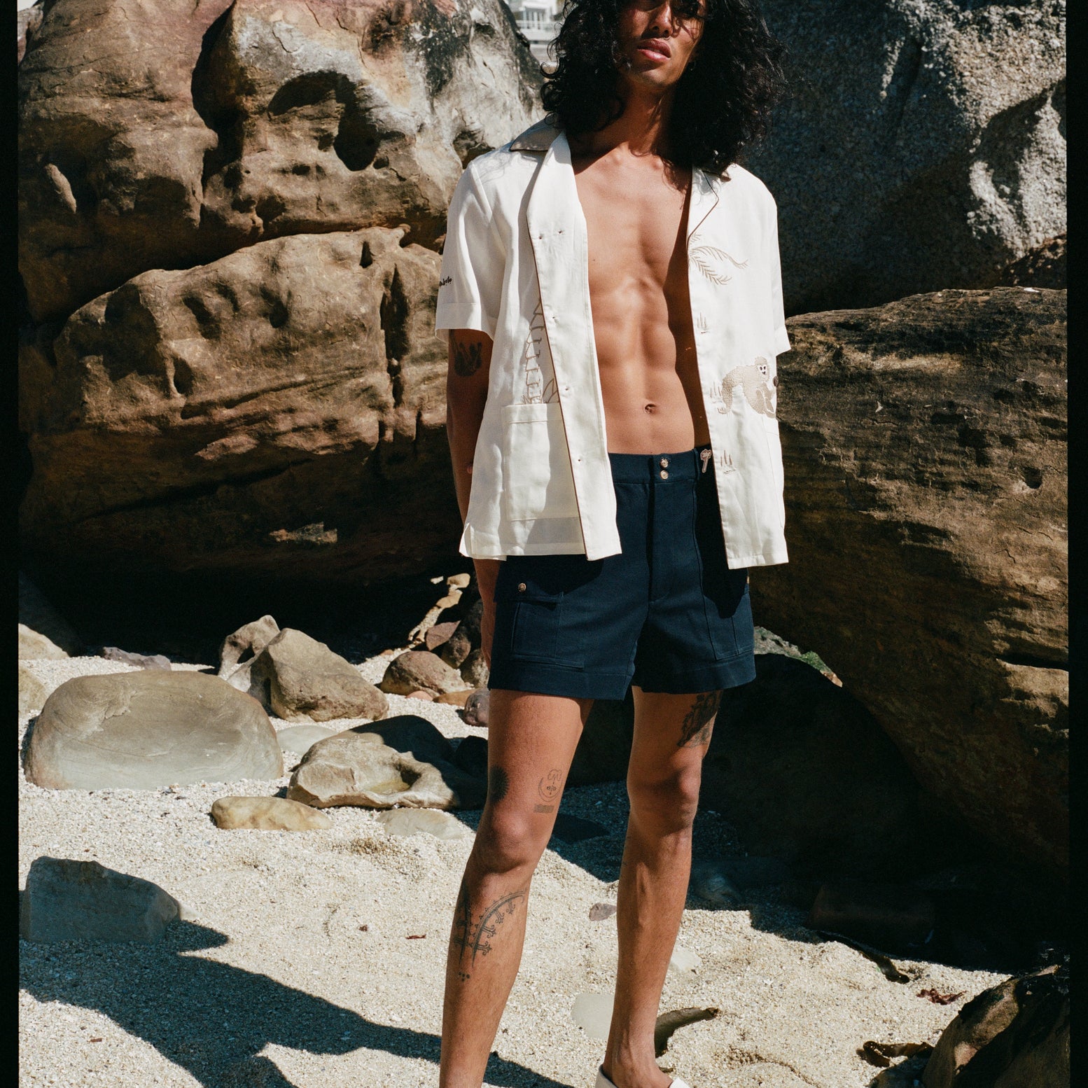 model wears unbuttoned shirt