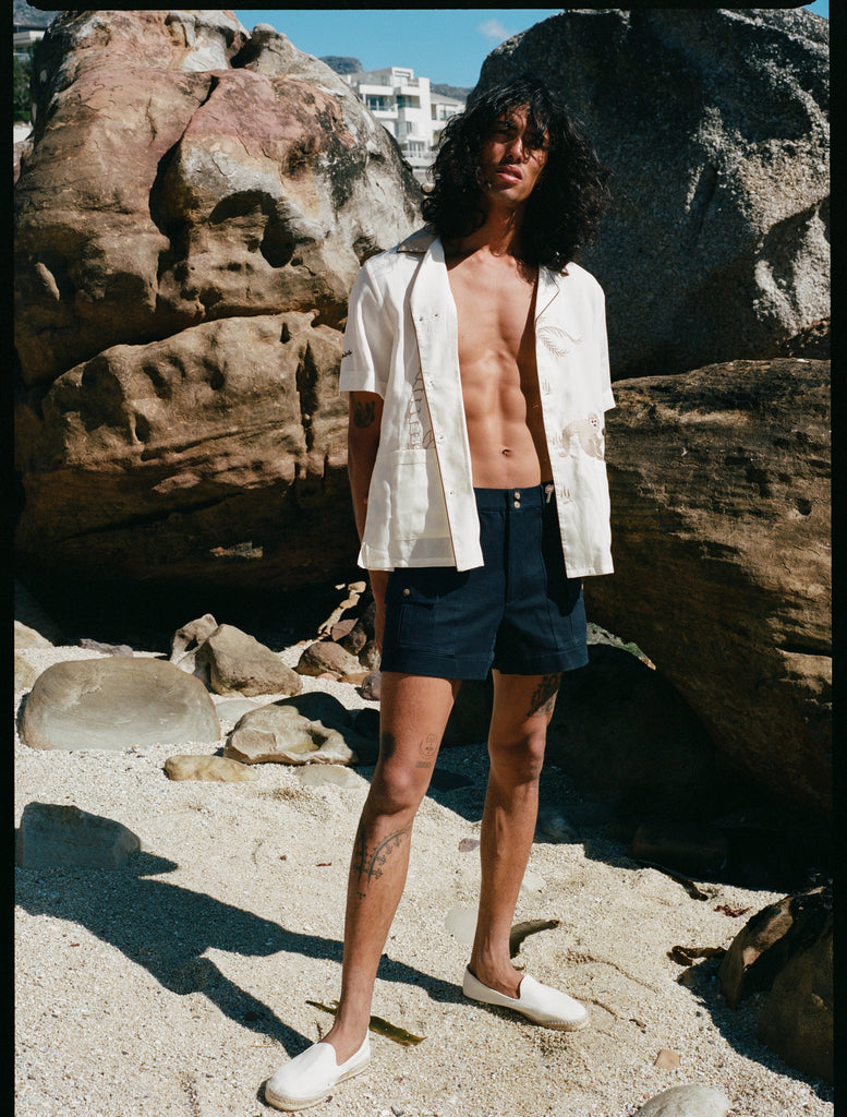 model wears unbuttoned shirt