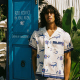 model stands next to blue door