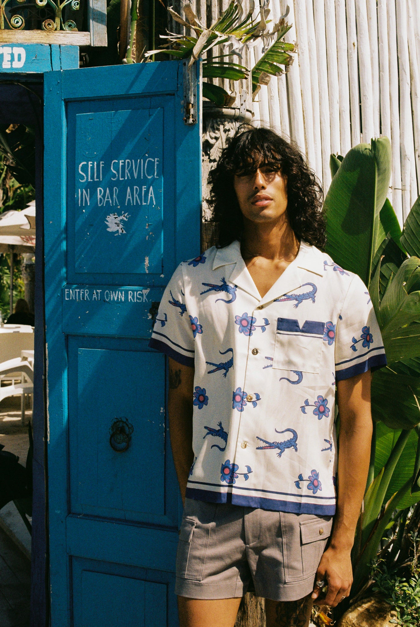 model stands next to blue door