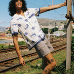 model holds onto telephone pole
