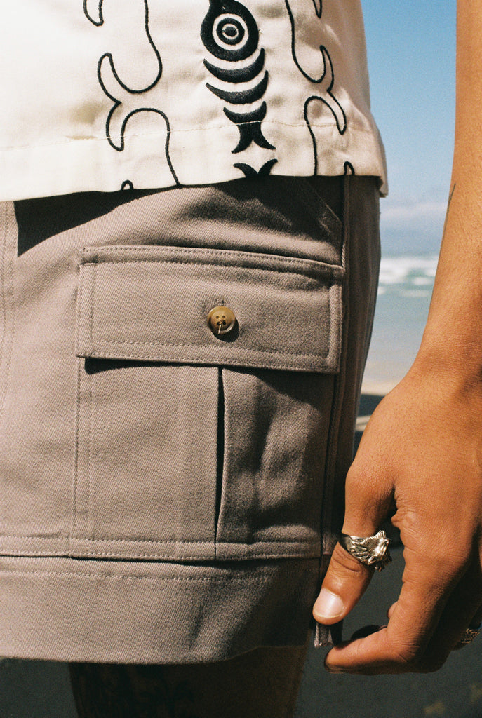 cose up of shorts and model's hand with ring