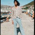 Male model posing in tee standing on pier