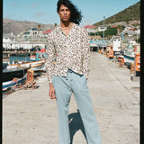 Male model posing in tee standing on pier