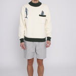 Male model standing with arms by his side wearing the sweater