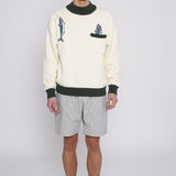 Male model standing with arms by his side wearing the sweater