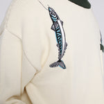 Close up of the embroidered over the shoulder fish and hook