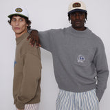 Male model wearing cap with arm on another male models back