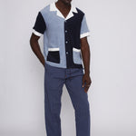 male model in studio with hand in pants pocket