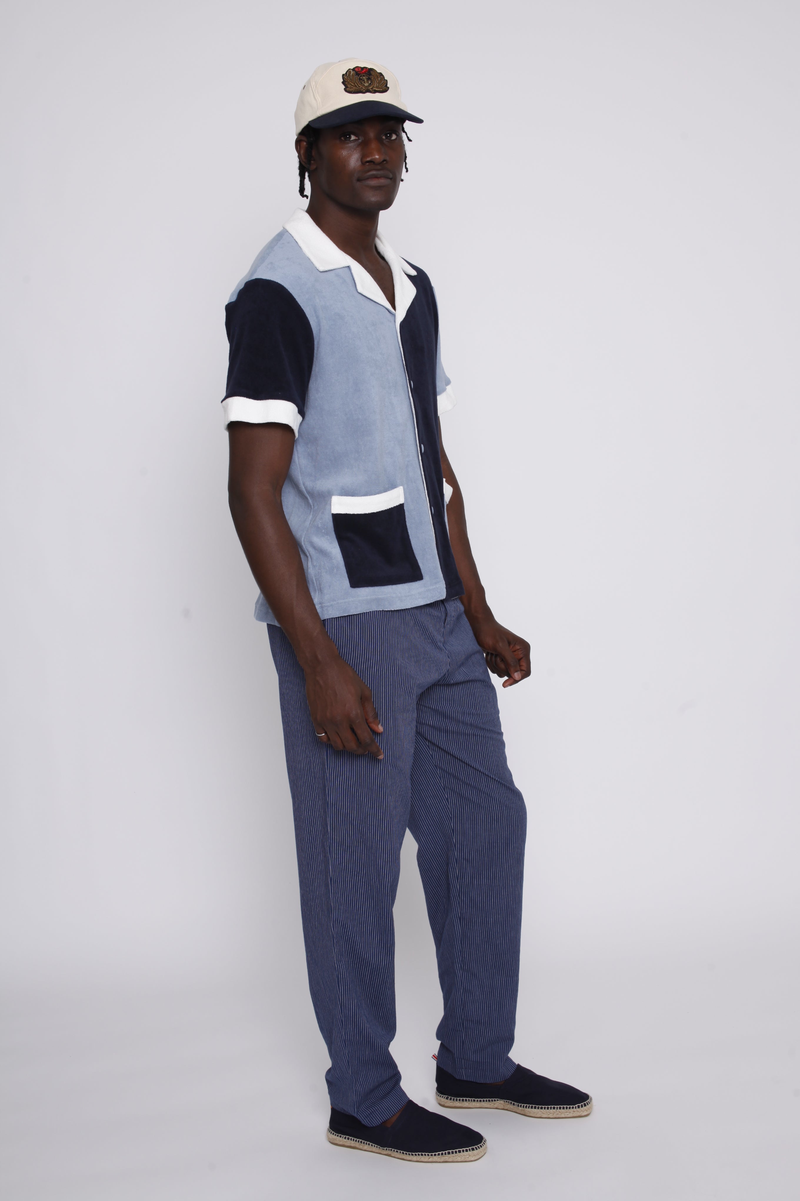 Male model gazing over left shoulder in the blues cabana