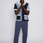 Male model wearing cap posing in studio with hands clasped in prayer in front of his mouth
