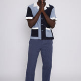 Male model wearing cap posing in studio with hands clasped in prayer in front of his mouth