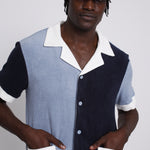 male model with hands in pockets looking at camera