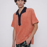 male model wearing polo in photo studio alone with easy going Crouching Tiger, Hidden Beverage pants