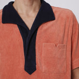 Close up of navy collar and apricot v cut pocket on male model