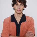 male model wearing polo with arms crossed