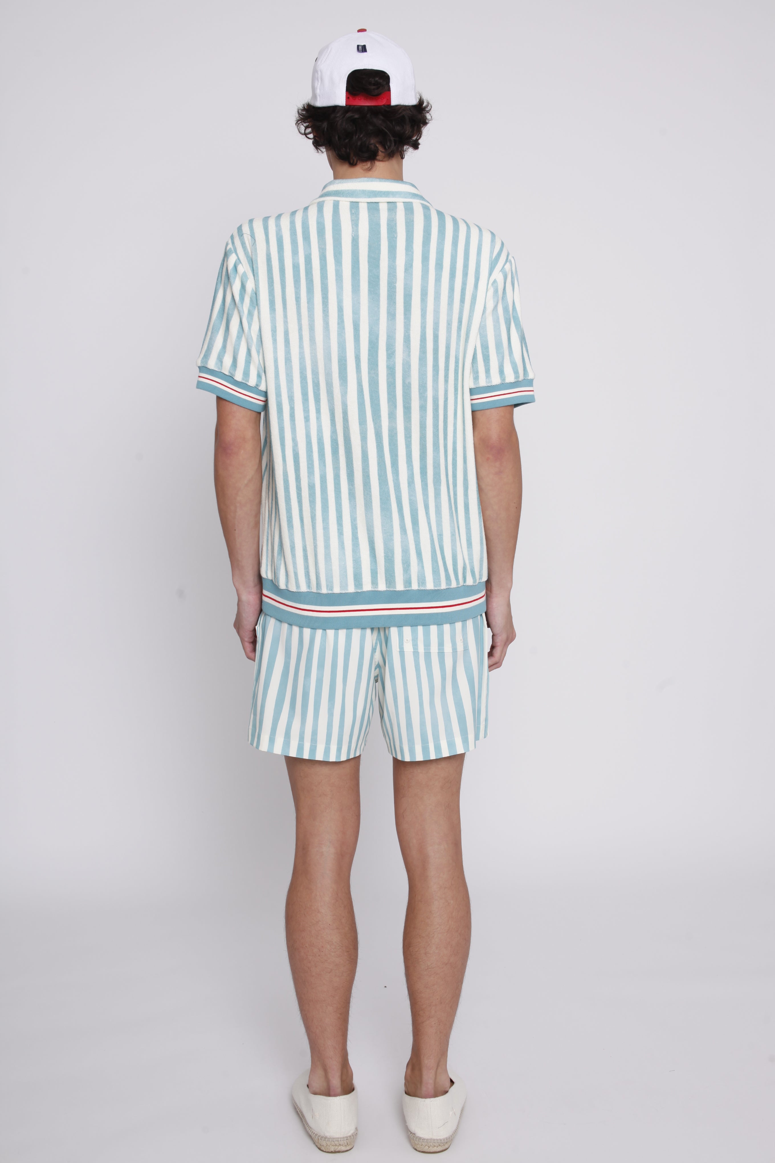 Back view of male model wearing shorts and cabana