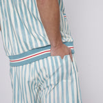 Male model tucking hand in back pocket of swim trunks