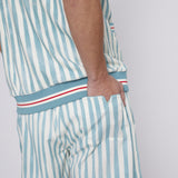 Male model tucking hand in back pocket of swim trunks