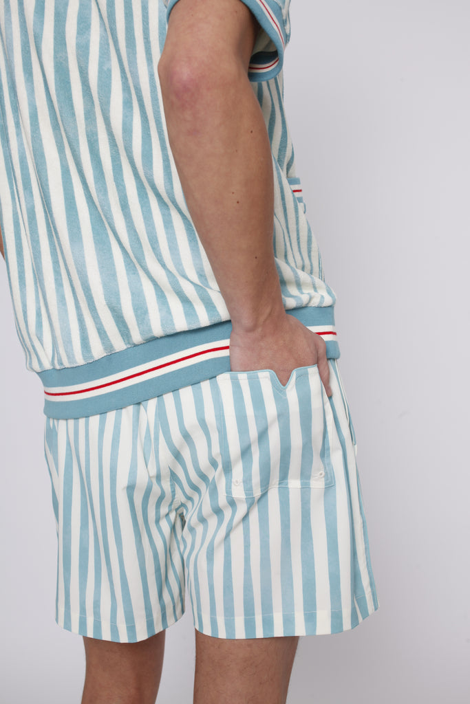 Male model tucking hand in back pocket of swim trunks