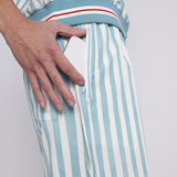 Male model putting phone in zippered pocket of trunks