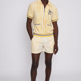 A person wearing a yellow and white striped shirt